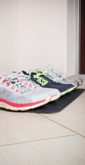 Family sports sneakers on the rug at the front door. The concept of a healthy lifestyle - 766620985