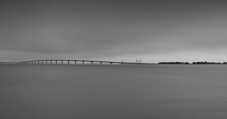 panoramic photo of the ile de re bridge in the fog. monochrome shot - obrazy, fototapety, plakaty