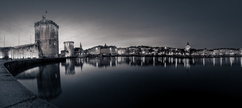 Fototapeta beautiful illuminated cityscape of the old harbor of La Rochelle. black and white photography