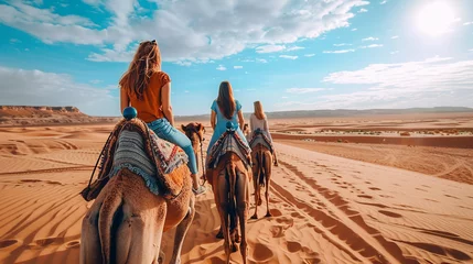 Foto auf Leinwand A photo of friends riding camels across a vast desert landscape, experiencing the beauty and tranquility of the desert happiness, love and harmony © Лариса Лазебная