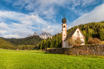 Church of St. John against the Geisler mountains in Santa Magdalena village, Val Di Funes in...