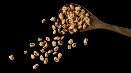 Puffed wheat cereal flakes isolated on black, top view - 766629501