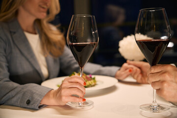 Couple at dinner tenderly holds hands