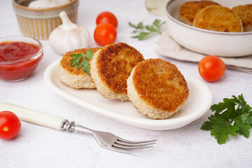 Plate of tasty meat cutlets on white background