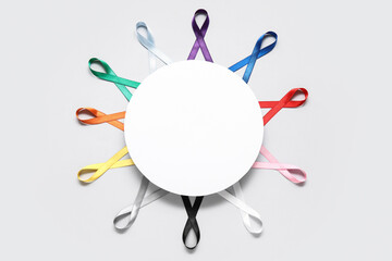 Blank card with different colorful ribbons on grey background. Cancer awareness concept