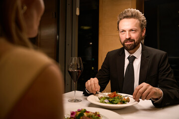 Elegant man is having dinner in a restaurant