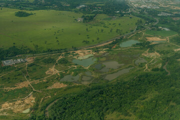 Beautiful nature in Brazilian lands with a lagoon, or river and its curves, seen from the top of an airplane, in aerial photographs