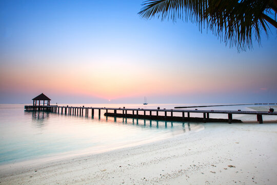 Sunrise over a pier in the Maldives