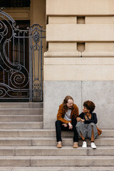 Affectionate couple sharing a moment on city steps, love and urban life