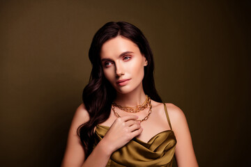 Photo of adorable rich lady wear khaki silky dress and golden jewellery isolated on brown gradient color background