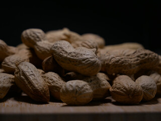 A pile of dried peanuts in shell close up. Healthy protein food