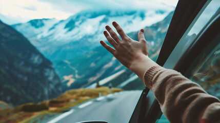 Hands of a woman in the car on the background of mountains