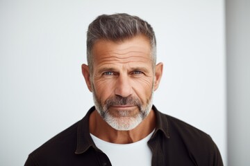 Portrait of a handsome mature man with gray hair and beard.