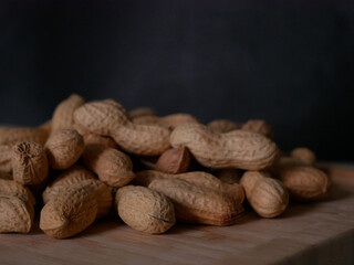 A pile of dried peanuts in shell close up. Healthy protein food