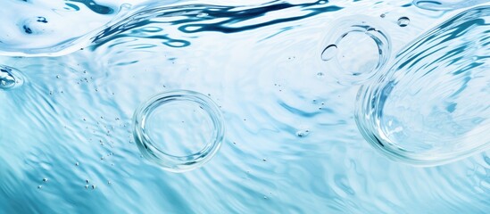 An up-close view of the surface of blue water featuring small bubbles scattered throughout