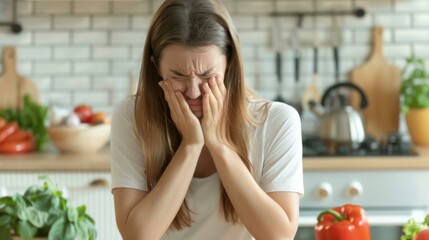 A sad woman sitting at a kitchen table with her hands covering her face. Generative AI.