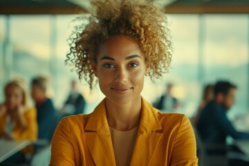 A woman with curly hair in a yellow jacket sitting at her desk. Generative AI.