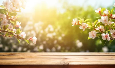 Poster Wooden table in a blooming spring garden © xamtiw