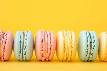 Foto op Canvas A vibrant array of macarons stand in a precise row against a bright yellow background, showcasing confectionery perfection. © Zography