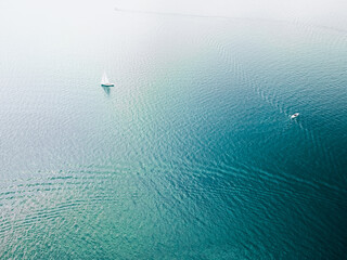 Aerial view of a white speed boat sailing in the blue sea.Drone view of a boat 