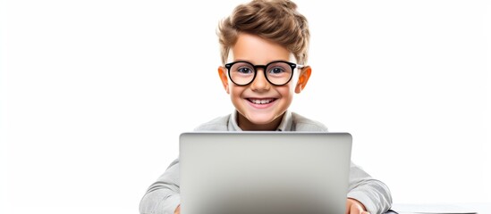 A happy young boy with glasses is smiling while sitting in front of a laptop computer. His vision care, jaw, beard, and gadget all contribute to his joyful gesture as he explores art online