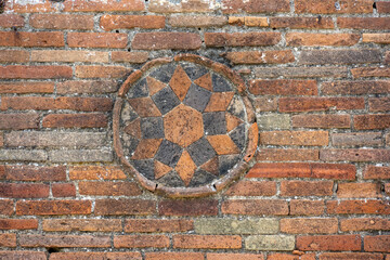 Ancient Roman Brickwork with a circular design in Pompeii, Italy