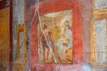 Colourful ancient Roman frescos on a wall in Pompeii, Italy