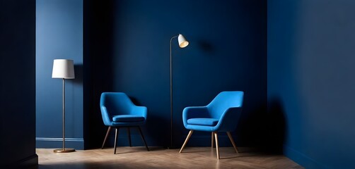 two blue chairs and a lamp in a dark room