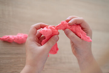 preschool girl makes figures from plasticine, Close-up of child's fingers skillfully manipulating...