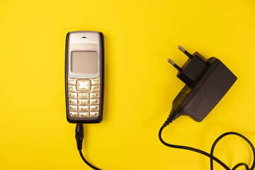 Vintage cellphone on a yellow background