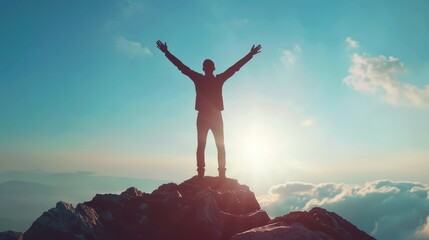 Silhouette of businessman celebrating raising arms on the top of mountain with over blue sky and sunlight. - obrazy, fototapety, plakaty