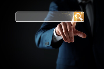 Man pointing at search bar on virtual screen against black background, closeup