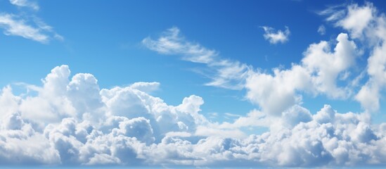 The sky was a stunning electric blue, with fluffy white cumulus clouds scattered across the...