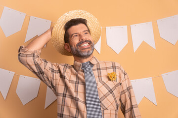 cheerful bearded man to Brazilian Junina Festival in studio shot. smiling and standing 