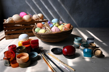 Painting the easter eggs setting on the old white wooden top.