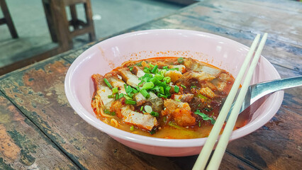Tom Yum Yellow Noodles with Crispy Pork, Spicy Thai Noodle with egg and red bbq pork