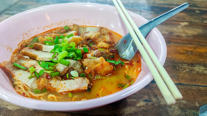Tom Yum Yellow Noodles with Crispy Pork, Spicy Thai Noodle with egg and red bbq pork
