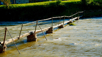 Wood water wheel Baler Machine in Agriculture Farm impeller lifted pumping water in river. Wooden Water Baler Machine green garden Farm blades by windy natural. Sustainable Resources Environment © aFotostock