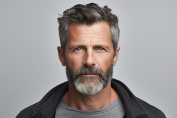 Portrait of handsome mature man with grey beard and mustache. Studio shot.