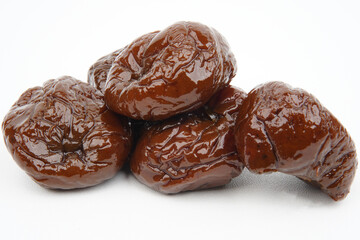 Closeup of sweet dried plums isolated background