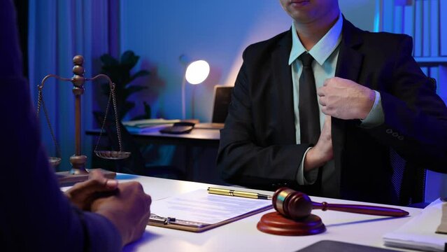 Giving banknotes, bribing a young Asian businessman, lawyer, shaking hands after receiving dollars after winning a case Extorting money from customers in legal cases legal corruption concept.