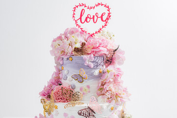 pink wedding cake with decoration with pink flower and cream on white,Food and flower wedding concept. - 766751957