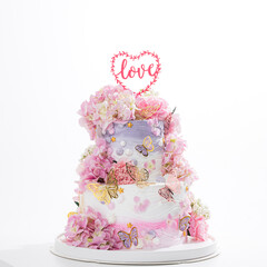 pink wedding cake with decoration with pink flower and cream on white,Food and flower wedding concept. - 766751997