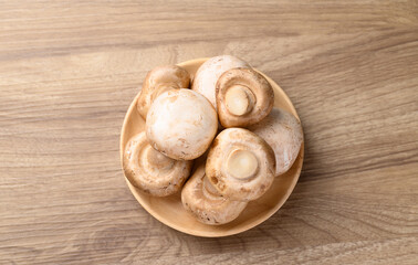 Fresh Champignon mushroom on wooden background, Table top view