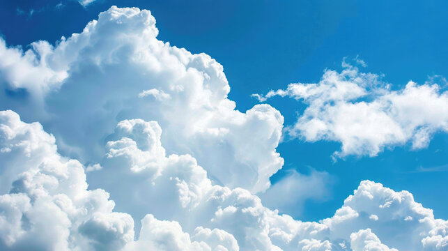 Large white clouds against a blue sky background