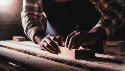 Wall murals Old airplane Carpenter's hands planing a plank of wood with a hand plane, in factory, old, dark 