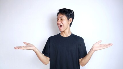young asian man excited gesturing showing both open palms - obrazy, fototapety, plakaty