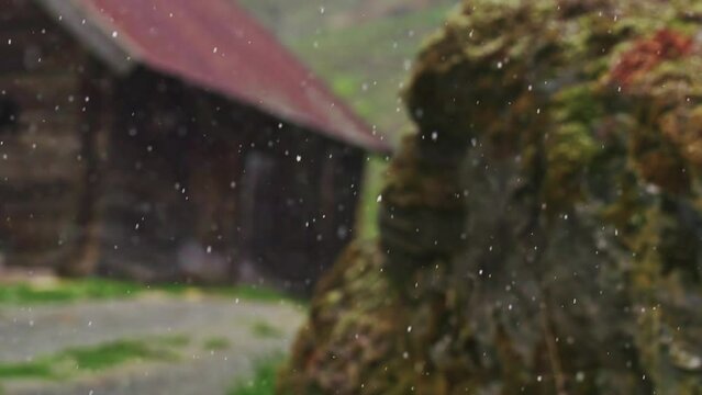 Wooden lodge with snow falling slowly, focus pull