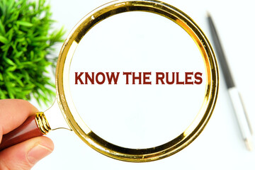 Know the rules text through a magnifying glass on a white background