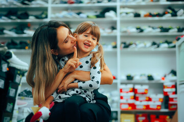 Mom Saying No to her Misbehaving Daughter in Shoe Store. Mother explaining the rules of good...